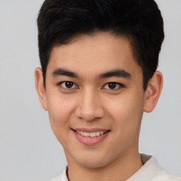 Joyful latino young-adult male with short  brown hair and brown eyes