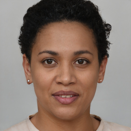 Joyful latino young-adult female with short  brown hair and brown eyes