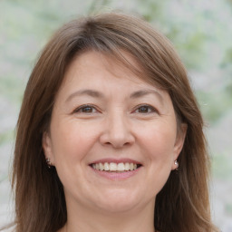 Joyful white adult female with medium  brown hair and brown eyes