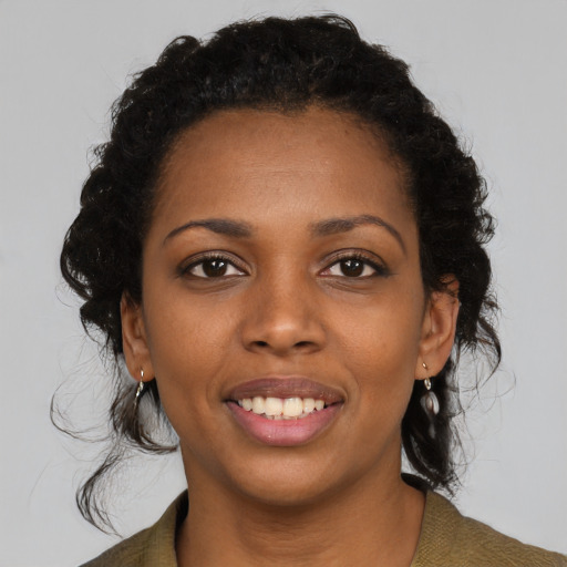 Joyful black young-adult female with medium  black hair and brown eyes