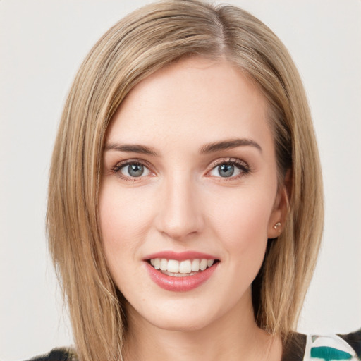 Joyful white young-adult female with medium  brown hair and green eyes