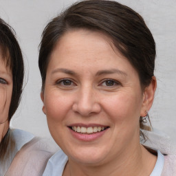 Joyful white adult female with medium  brown hair and brown eyes