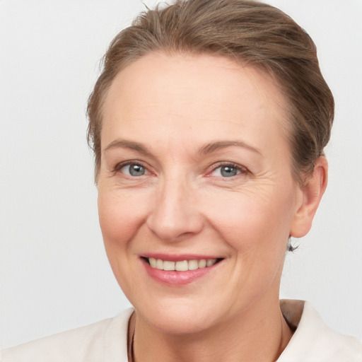 Joyful white adult female with short  brown hair and grey eyes