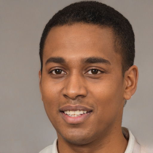 Joyful black young-adult male with short  brown hair and brown eyes