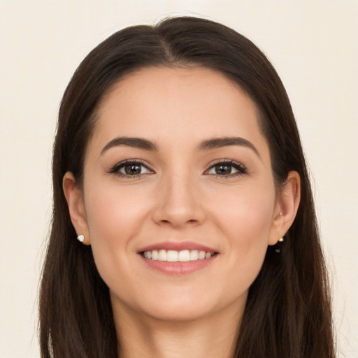 Joyful white young-adult female with long  brown hair and brown eyes