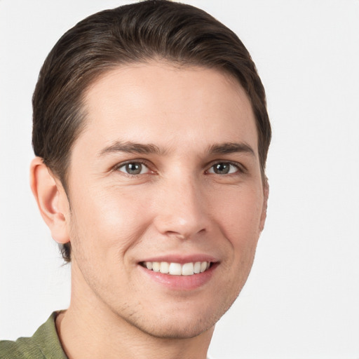 Joyful white young-adult male with short  brown hair and grey eyes