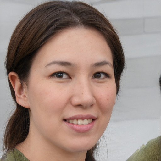 Joyful white young-adult female with medium  brown hair and grey eyes