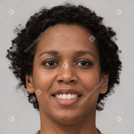 Joyful black young-adult female with short  brown hair and brown eyes