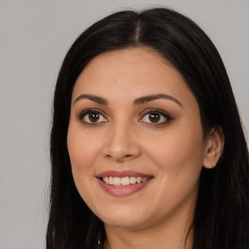 Joyful white young-adult female with long  black hair and brown eyes