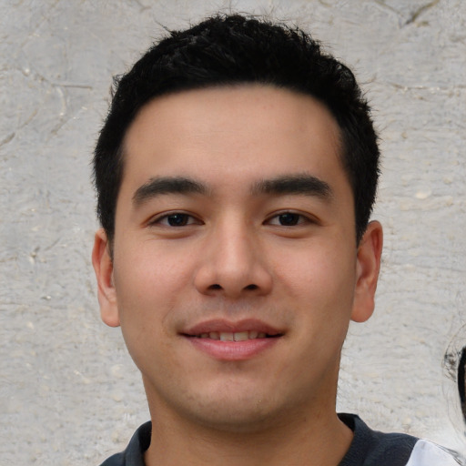 Joyful asian young-adult male with short  black hair and brown eyes