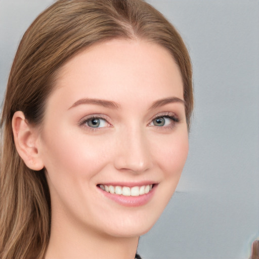 Joyful white young-adult female with long  brown hair and blue eyes