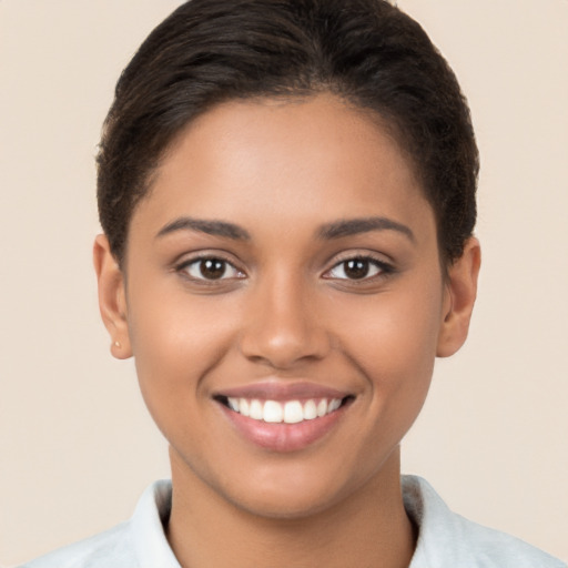 Joyful latino young-adult female with short  brown hair and brown eyes