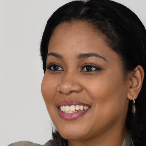 Joyful black young-adult female with medium  black hair and brown eyes