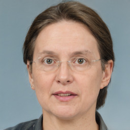 Joyful white adult female with medium  brown hair and grey eyes