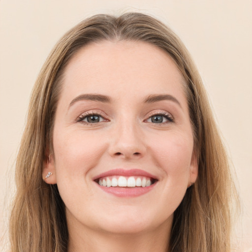 Joyful white young-adult female with long  brown hair and grey eyes