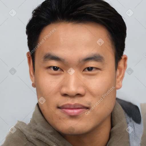 Joyful asian young-adult male with short  black hair and brown eyes