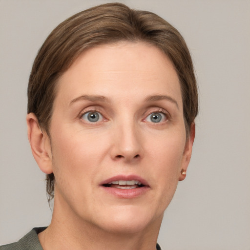 Joyful white adult female with short  brown hair and grey eyes