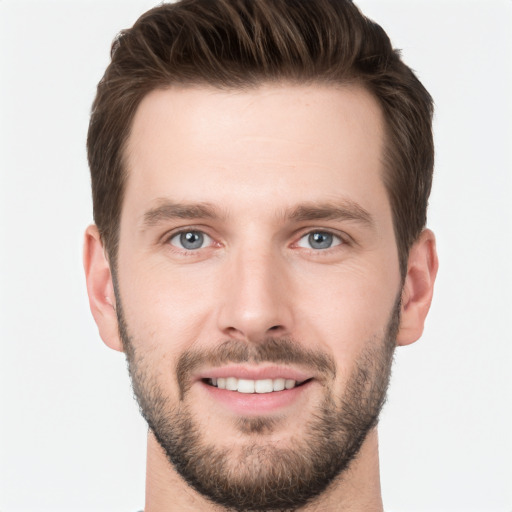 Joyful white young-adult male with short  brown hair and grey eyes