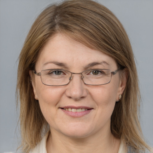 Joyful white adult female with medium  brown hair and grey eyes