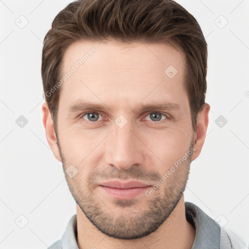 Joyful white young-adult male with short  brown hair and grey eyes