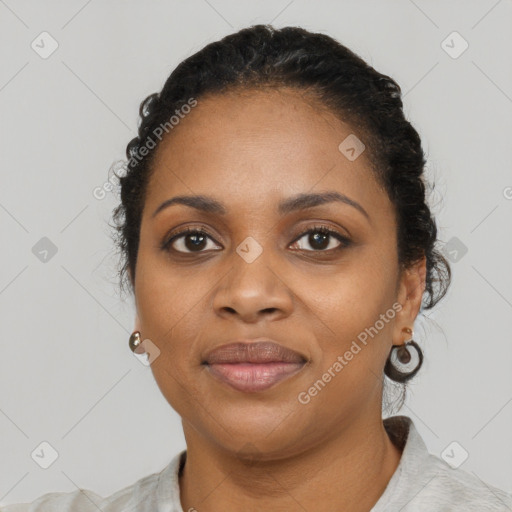 Joyful black young-adult female with short  black hair and brown eyes