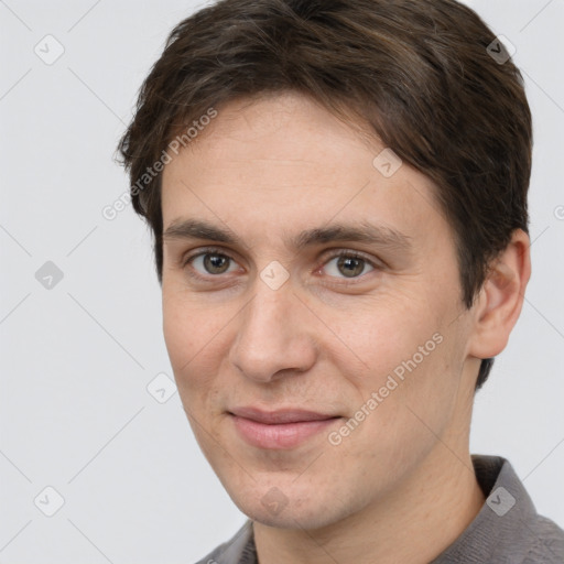 Joyful white adult male with short  brown hair and brown eyes