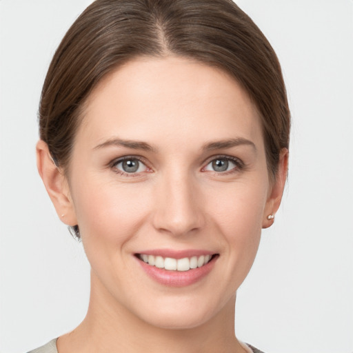 Joyful white young-adult female with short  brown hair and grey eyes