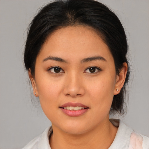 Joyful asian young-adult female with medium  brown hair and brown eyes