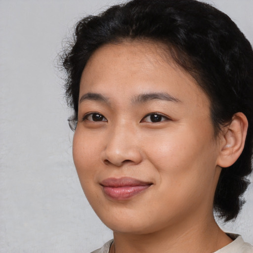 Joyful asian young-adult female with medium  black hair and brown eyes