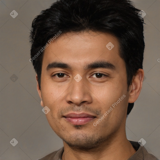 Joyful asian young-adult male with short  black hair and brown eyes