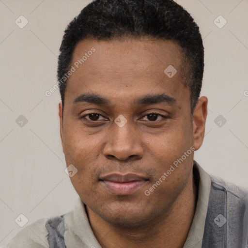 Joyful black young-adult male with short  black hair and brown eyes