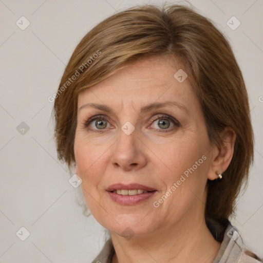 Joyful white adult female with medium  brown hair and blue eyes