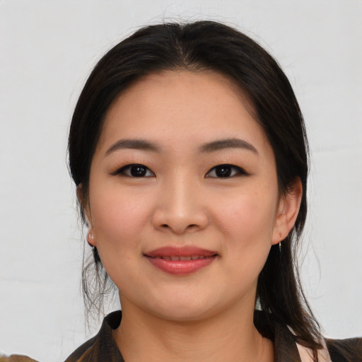 Joyful white young-adult female with medium  black hair and brown eyes