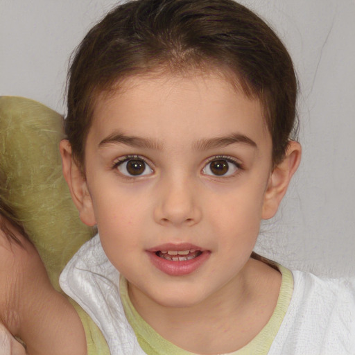 Joyful white child female with medium  brown hair and brown eyes