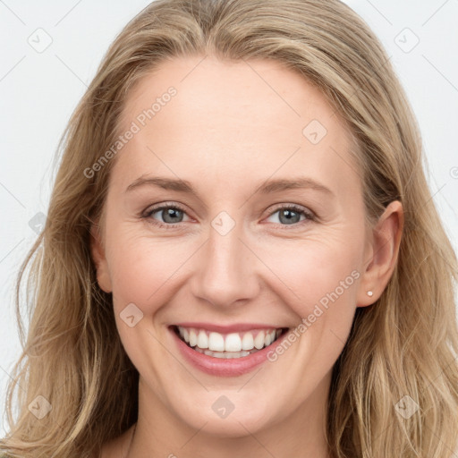 Joyful white young-adult female with long  brown hair and blue eyes