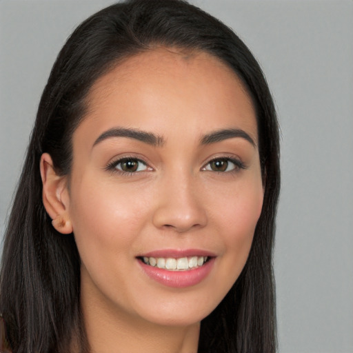 Joyful white young-adult female with long  brown hair and brown eyes