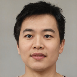 Joyful asian young-adult male with short  black hair and brown eyes