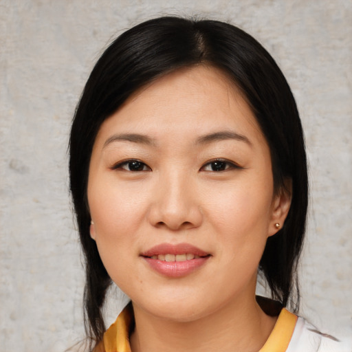 Joyful asian young-adult female with medium  black hair and brown eyes