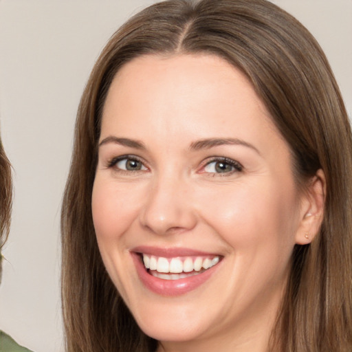 Joyful white adult female with long  brown hair and brown eyes