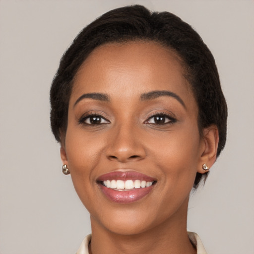 Joyful latino young-adult female with short  brown hair and brown eyes