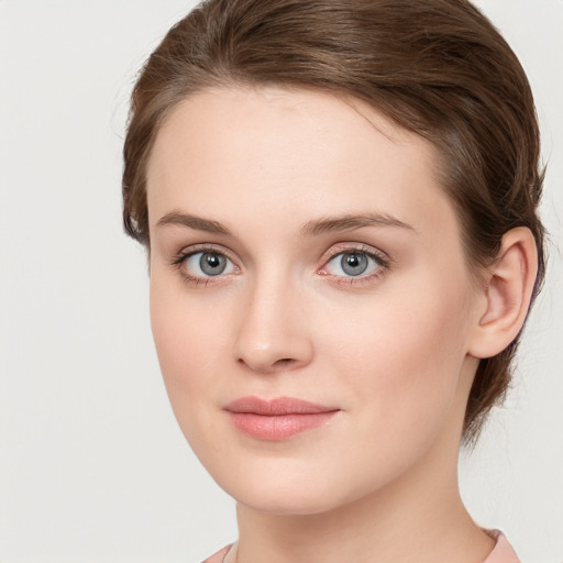 Joyful white young-adult female with long  brown hair and blue eyes