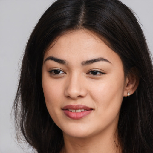 Joyful asian young-adult female with long  brown hair and brown eyes