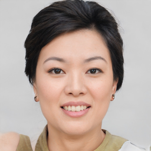 Joyful asian young-adult female with short  brown hair and brown eyes