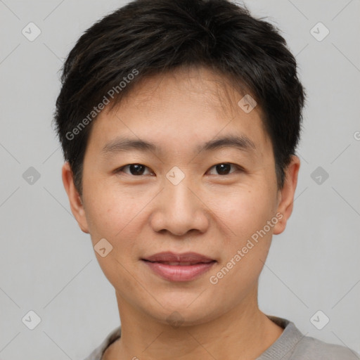 Joyful asian young-adult male with short  brown hair and brown eyes