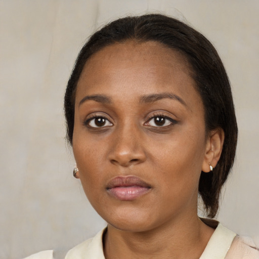 Neutral black young-adult female with medium  brown hair and brown eyes