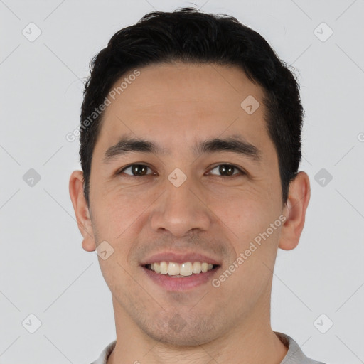 Joyful asian young-adult male with short  brown hair and brown eyes