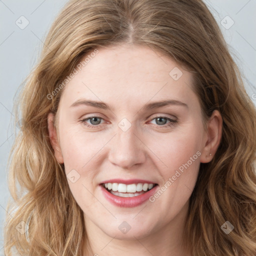 Joyful white young-adult female with long  brown hair and blue eyes