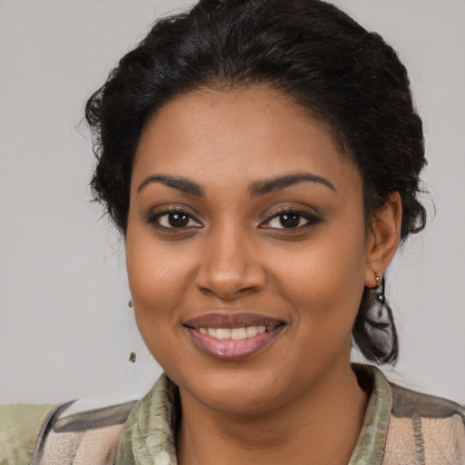 Joyful black young-adult female with medium  brown hair and brown eyes