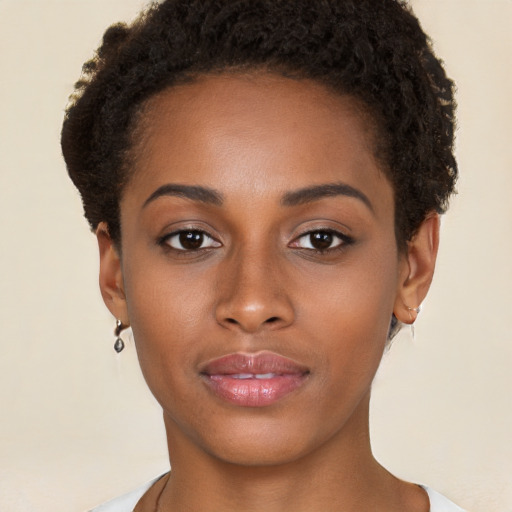 Joyful black young-adult female with short  brown hair and brown eyes