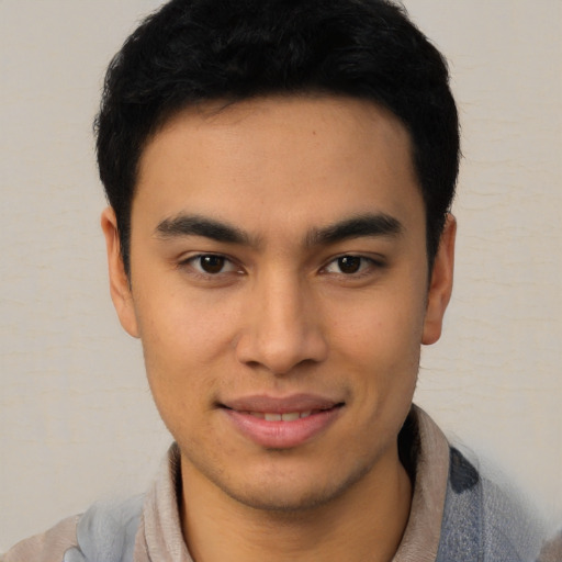 Joyful latino young-adult male with short  brown hair and brown eyes